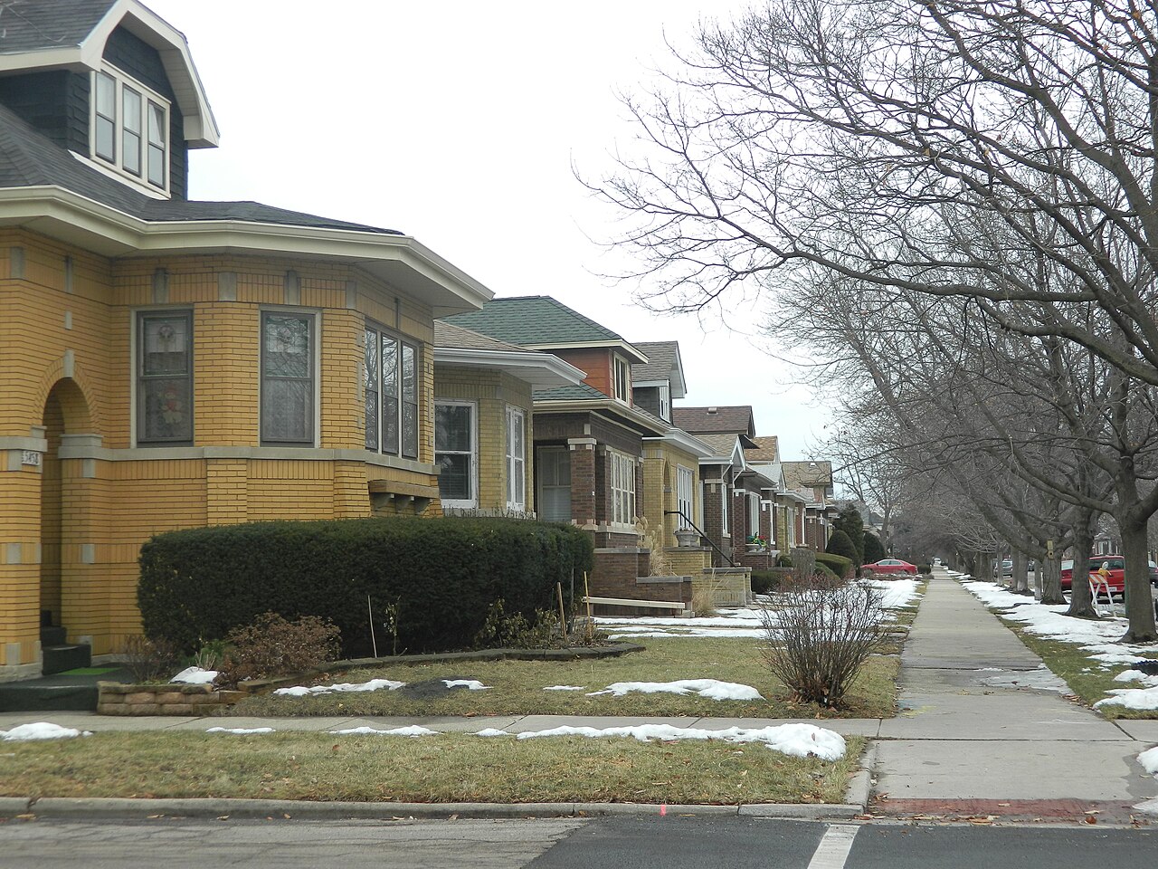 A row of brick bungalow houses along a residential street in Chicago's Portage Park neighborhood.