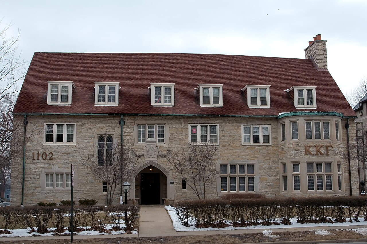A large late-nineteenth-century house with a broad front porch in Urbana, Illinois.