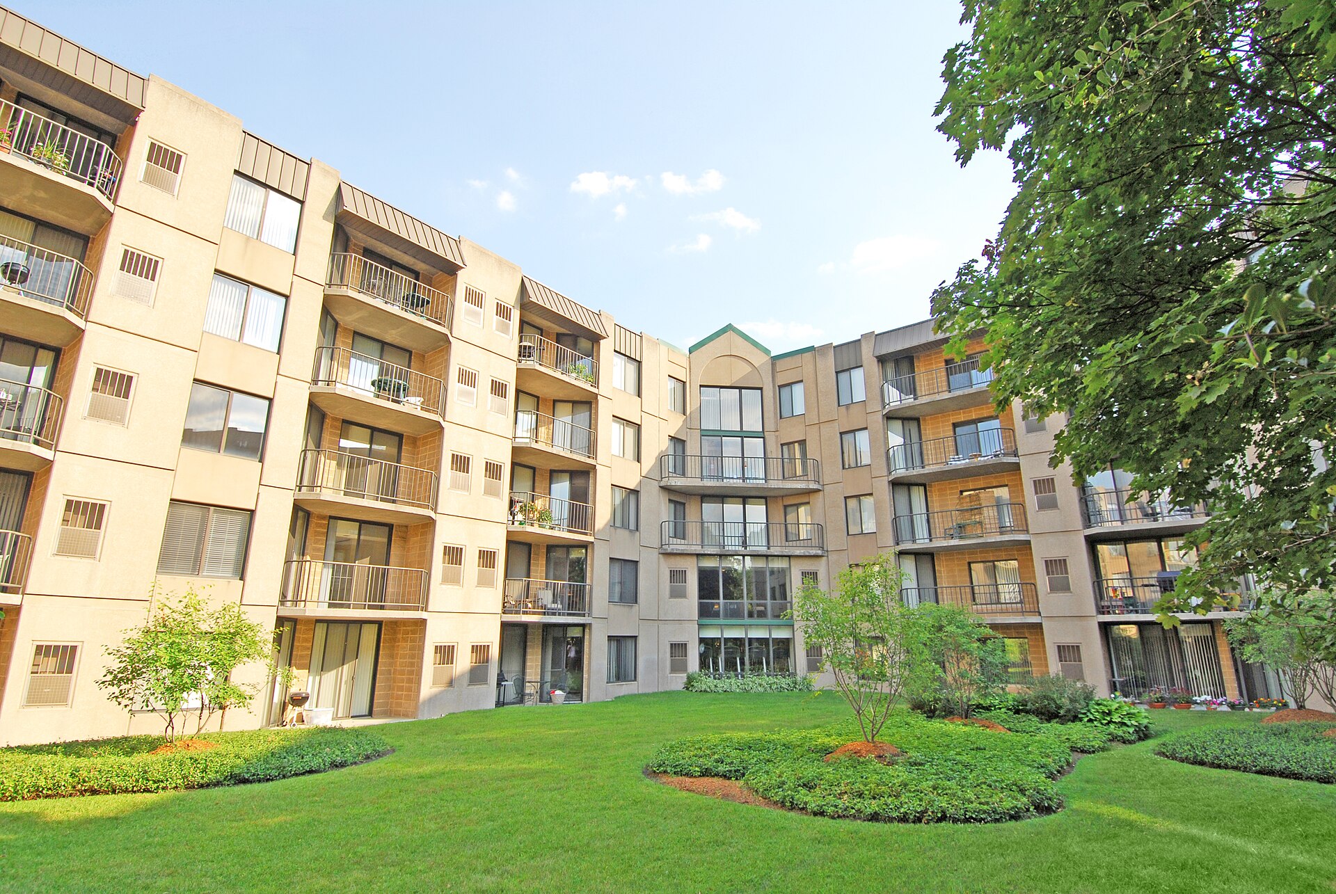 Landscaped courtyard and apartment buildings at Elm Creek in Elmhurst, Illinois