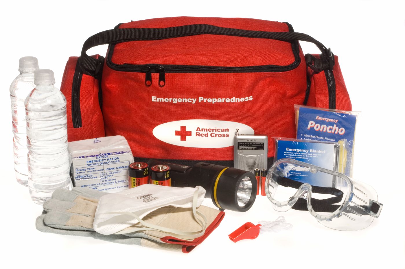 A red emergency-preparedness kit bag displayed with water, food, batteries, a flashlight, a blanket, and other supplies.